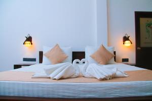 Voodi või voodid majutusasutuse Amare Safari Resort Udawalawe toas