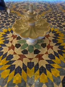 a vase on a floor with a mosaic pattern at Palais Du Desert Hotel & Spa in Erfoud