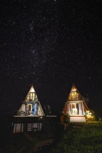 dos casas por la noche bajo un cielo estrellado en The Soul Stroll Cottages Retreat en Mukteswar