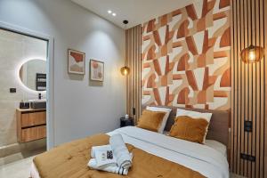 a bedroom with a large bed with orange pillows at Apartment Montmartre by Studio prestige in Paris