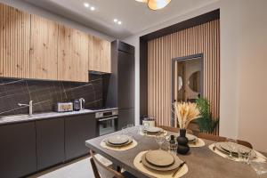 a kitchen with a table with chairs and a sink at Apartment Montmartre by Studio prestige in Paris +13 photos