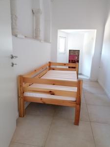 a bedroom with a wooden bed in a room at Villa Rapunzel in Brovinje