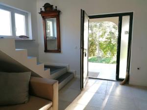 a living room with stairs leading to a door at Villa Rapunzel in Brovinje