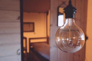 a light bulb hanging from the side of a train at Luxe glamping tent in Bant
