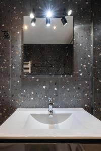 a bathroom with a sink and a mirror at Hippocrates bound by BiNoBi! in Thessaloniki