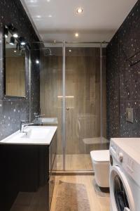 a bathroom with a toilet and a sink and a washing machine at Hippocrates bound by BiNoBi! in Thessaloniki