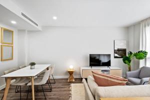 a living room with a couch and a table at CATERINA Mar Bella in Barcelona