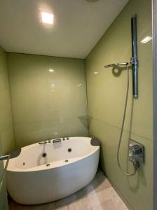 a bathroom with a bath tub and a shower at Lovely 3 Rooms with KLCC View, Pavilion & Netflix in Kuala Lumpur