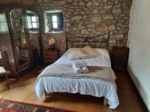 a bedroom with a bed with two stuffed animals on it at Casa Rural Goikitxe Etxea in Goizueta