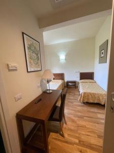 a room with two beds and a desk with a table at Toscani da sempre in Pontassieve +37 photos