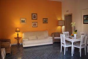 a living room with a couch and a table with chairs at Palazzo Doria in Marsala