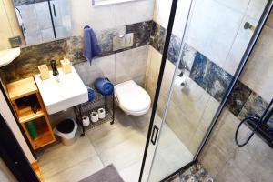 a bathroom with a toilet and a sink and a shower at Heaven's Edge in São Brás de Alportel