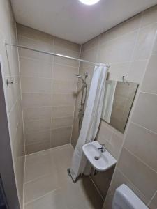 a bathroom with a shower and a sink at Mythos Hotel Oranienburg in Oranienburg
