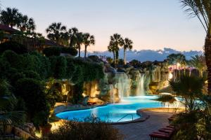 a pool at a resort with a waterfall at Hyatt Regency Grand Cypress Resort in Orlando