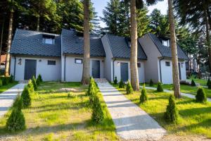 a house with trees in front of it at Boro Green Holiday Village in Borovets