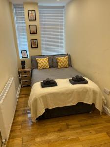 a bedroom with a bed with two towels on it at Spacious ground floor suite comfortably sleeps up to eight in Halifax