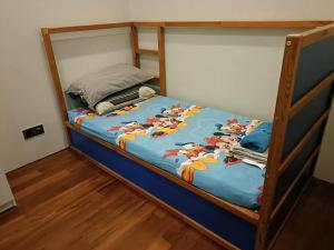 a bunk bed with a blue comforter on it at 3 Guests,200m to KLCC & Pavilion Mall with Netflix in Kuala Lumpur