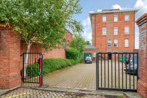 a gate in front of a brick building at County House Escape - courtyard & free parking in York