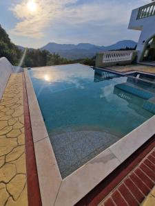 a swimming pool with a view of the mountains at Olive Villa in Episkopianá