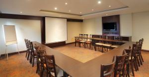 a conference room with a long table and chairs at StayEasy Rustenburg in Rustenburg
