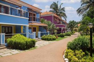 a row of colorful houses on a street at Radisson Blu Resort, Goa in Cavelossim