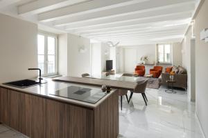 a kitchen and living room with a counter and a living room at Maison MUSA at Vita B in Lenno
