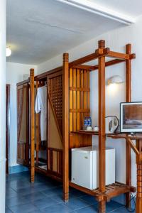 a room with wooden shelves and a white appliance at Sun N Sand Beach Resort in Mombasa