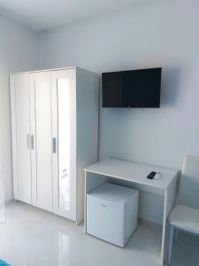 a room with a white desk and a white cabinet at Villa Milena Apartments & Rooms in Agropoli