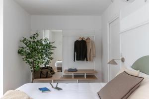 a bedroom with a bed and a dresser and a mirror at B48 Abando in Bilbao