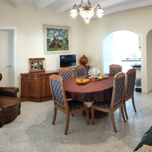 a dining room with a wooden table and chairs at Apartments in a "VILLA VISTA JAVEA" in Jávea
