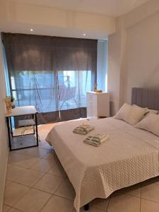 a bedroom with a bed and a large window at Hestia Airport House - Artemis in Artemida