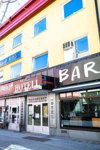 a row of store fronts on a street at Saga Hotell in Borlänge