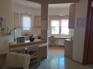 a kitchen with a table and a counter top at Airport Family House in Artemida