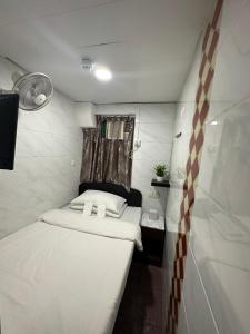 Ένα ή περισσότερα κρεβάτια σε δωμάτιο στο Mandarin Guest House