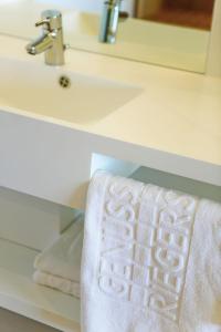 a bathroom sink with a white towel on a counter at Genusshotel Riegersburg in Riegersburg
