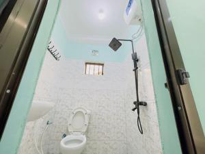an overhead view of a toilet in a bathroom at Karibu Eco-Hostel Arusha in Arusha
