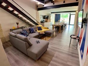 a living room with two couches and a dining room at LOFT Gare Cité Gastronomique Dijon in Dijon