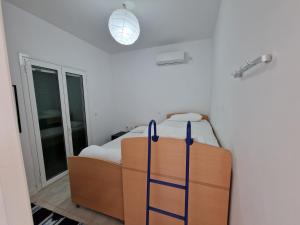 a bedroom with a bed and a light on the ceiling at Olive Villa in Episkopianá +13 photos