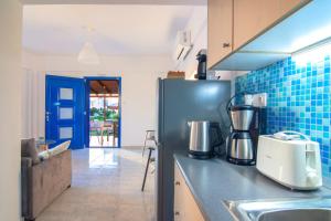 a kitchen with a counter top with a blender on it at Blue Breeze in Milatos