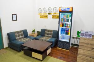 a room with a drink cooler and two couches at Chinor Garden Hotel - Free Airport Pick-up Yandex Go in Tashkent