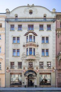 a large white building with a sign on it at K+K Hotel Central in Prague