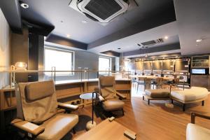 a salon with a waiting room with chairs and tables at Richmond Hotel Yokohama-Bashamichi in Yokohama