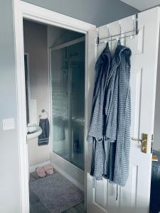 a bathroom with a shower and a glass door at The Grange in Admaston