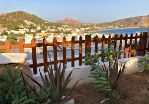 a wooden fence with a view of a beach at Lappa Hotel in Plakias