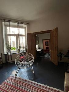 a living room with a chair and a window at Apartment in the center in Łódź