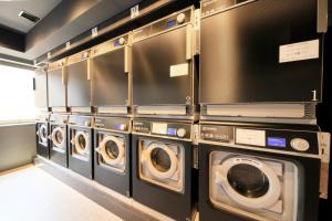 a row of washing machines in a laundry room at Richmond Hotel Yokohama-Bashamichi in Yokohama