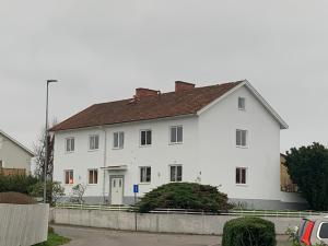 a large white house with a brown roof at 4 Bed Apartment with balcony in Karlskrona in Karlskrona