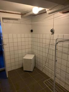 a room with a heater and tiled walls at 4 Bed Apartment with balcony in Karlskrona in Karlskrona +14 photos