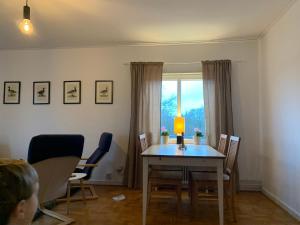a dining room with a table and chairs and a window at 4 Bed Apartment with balcony in Karlskrona in Karlskrona