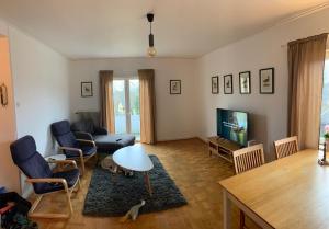 a living room with a couch and a tv at 4 Bed Apartment with balcony in Karlskrona in Karlskrona